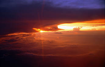 Bali sunset over Java island with volcano from aircraft