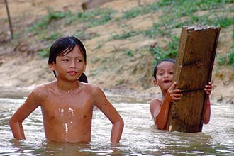 Iban Longhouses kids playing in the jungle river