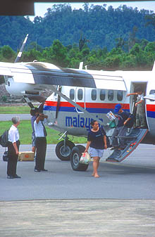 Mulu Airport passengers disembarking from Twin Otter aircraft