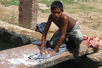 JAI Karauli in Rajasthan - boy doing the laundry with soap 3008x2000
