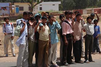 JAI Karauli in Rajasthan - local students on their way to the temple waving 3008x2000