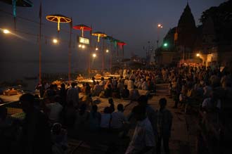 VNS Varanasi or Benares - Dasaswamedh Ghat pilgrims gathering for a religious ceremony by night 3008x2000