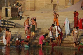 VNS Varanasi or Benares - Hindu pilgrims taking a bath in the holy Ganges river at sunrise 3008x2000