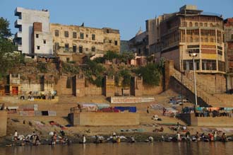 VNS Varanasi or Benares - dhobi wallahs (laundry men) doing the laundry in the holy Ganges river at sunrise at Lali Ghat 3008x2000