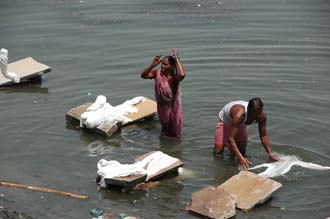 VNS Varanasi or Benares - dhobi wallahs (laundry men) doing the laundry in the holy Ganges river near Harishchandra Ghat 3008x2000