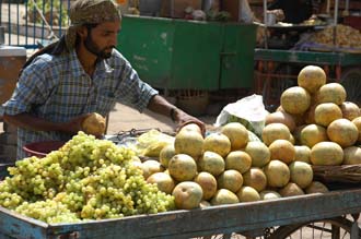 VNS Varanasi or Benares - fruit vendor preparing his stand 3008x2000