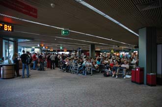 FCO Rome Fiumicino Airport - crowdy waiting area at the peak of the holiday season in mid-summer 3008x2000