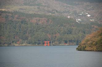 NRT Hakone - red Torii gate on Ashino-ko lake with colourful autumn leaves on trees seen from pirate ship ferry from Togendai to Hakone-machi 3008x2000