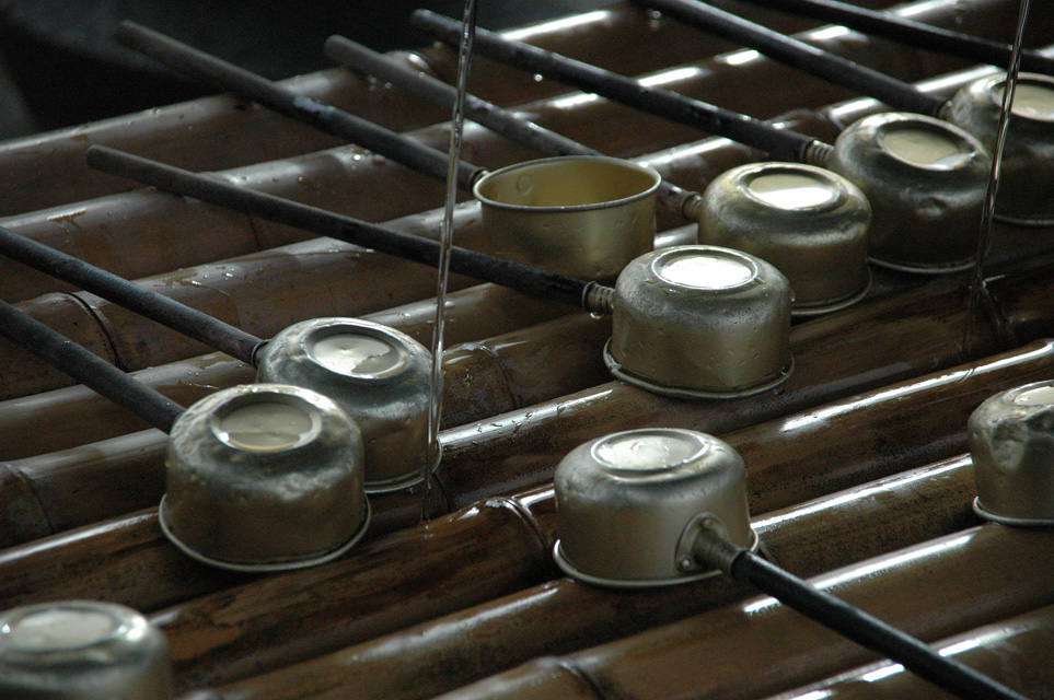 KIX Nara - Todai-ji temple long-handled ladles perched on a hishaku rack above the chozuya trough of water 3008x2000