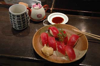 NRT Shinjuku Tokyo - simple Sushi meal of nigiri-zushi type with shoyu dip chopsticks gari or pickled ginger and cup of green tea 3008x2000