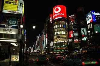 NRT Tokyo - Ginza shopping area with department stores and colourful advertisement lights by night 03 3008x2000