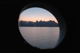 BMU Komodo Island Ombak Putih sailing ship porthole view of the island before sunrise 3008x2000