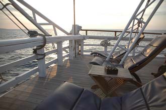 AMI Lombok Senggigi Ombak Putih sailing ship deck chairs on upper deck at sunset  3008x2000