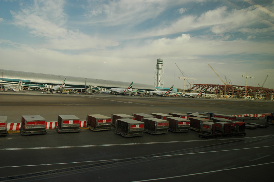 DXB Dubai International Airport - Terminal 1 with Tower and aircrafts and new terminal building under construction in january 2006 3008x2000