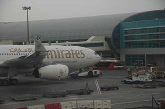 DXB Dubai International Airport - Terminal 1 with Emirates Airlines Airbus A330-200 aircraft at the gate 02 3008x2000