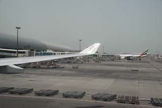 DXB Dubai International Airport - Terminal 1 with Emirates Airlines Boeing 777 aircraft at the gate 3008x2000