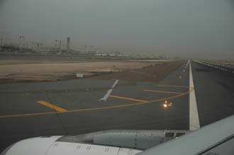 DXB Dubai International Airport - runway and Terminal 1 with Tower and aircrafts at the gates after landing 3008x2000
