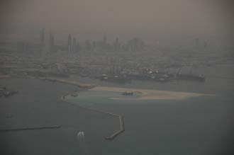 DXB Dubai from aircraft - Port Rashid land reclaiming and the Jumeirah skyscrapers at dawn 02 3008x2000
