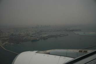 DXB Dubai from aircraft - Port Rashid land reclaiming and the Jumeirah skyscrapers at dawn 03 3008x2000