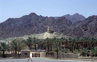 DXB Hatta Heritage Village - entrance gate with watchtower and Hajar mountains 5340x3400