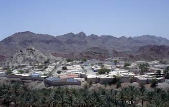 DXB Hatta Heritage Village - view from watchtower on Hatta town with palm plantation and dramatic mountain scenery 5340x3400