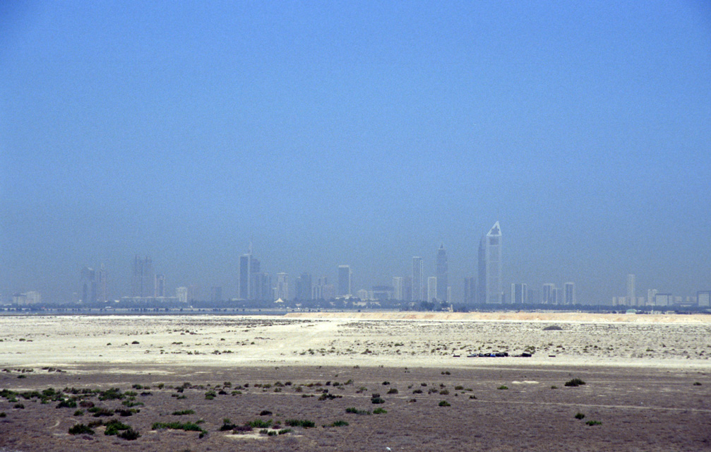 DXB Dubai - the skyline of Jumeirah with desert seen from the highway leaving Dubai in south-eastward direction towards Hatta Oasis 02 5340x3400